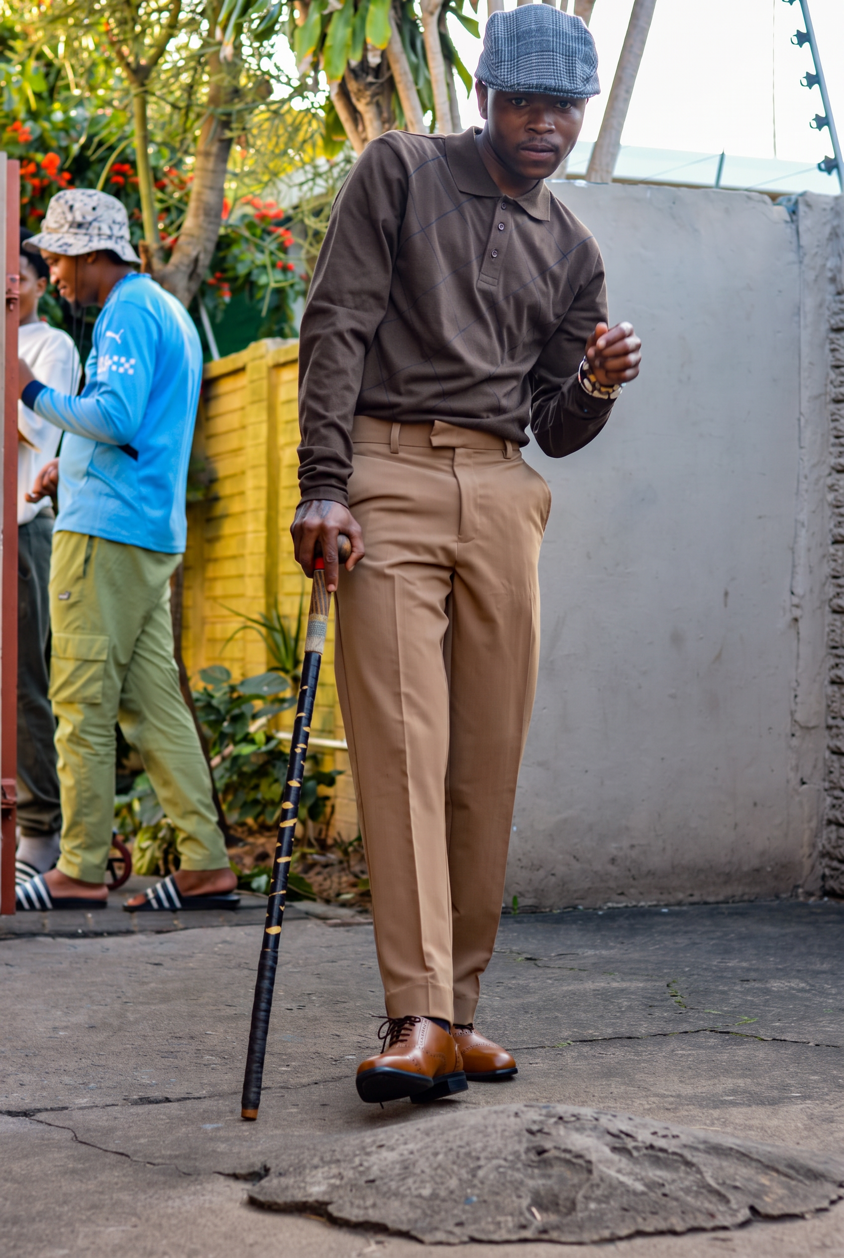 LatshuZAR on the street with a walking cane